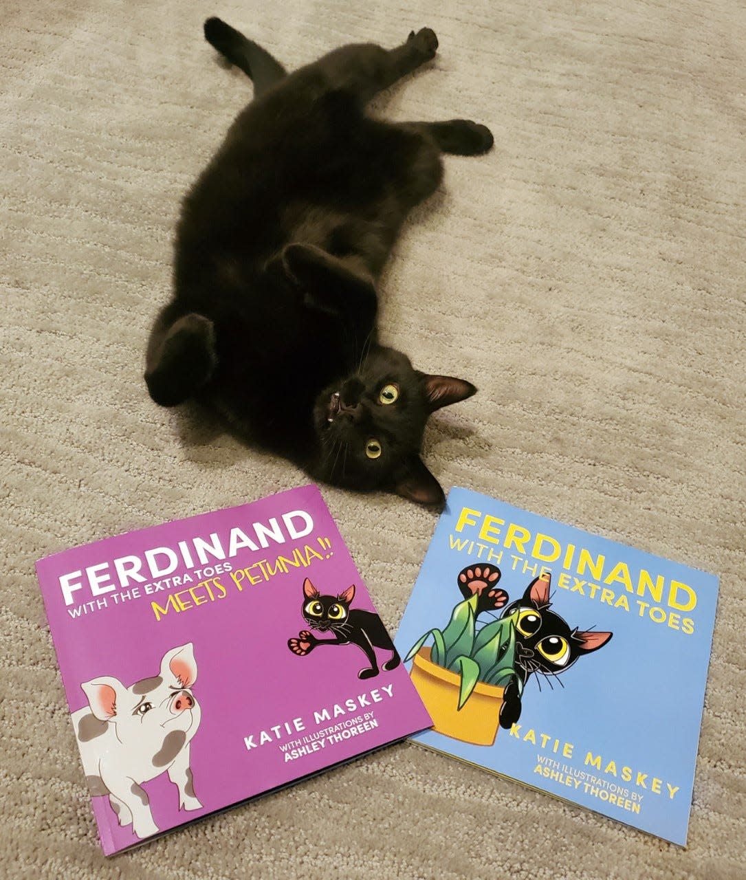 Ferdinand poses with the two books featuring him.