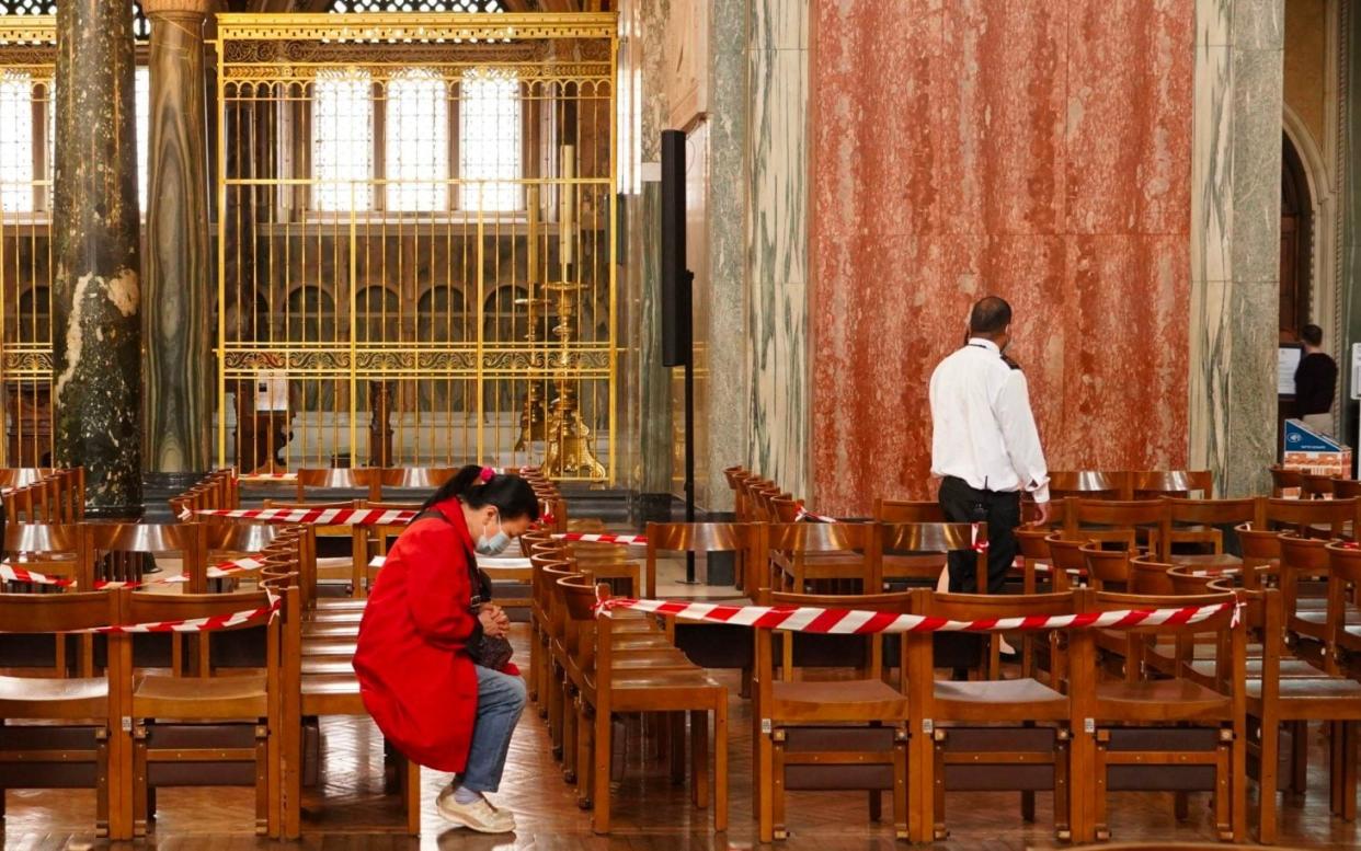 At Westminster Cathedral tape marks wide gaps between rows - AM EDWARDS / AFP via Getty Images