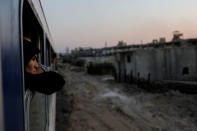 A woman looks out of a window of a train traveling through the outskirts of Damascus towards recently opened international fair in Damascus, Syria, September 12, 2018. REUTERS/Marko Djurica