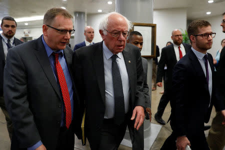 Sen. Bernie Sanders walks to the Senate floor ahead of votes on Capitol Hill in Washington, U.S., December 6, 2017. REUTERS/Aaron P. Bernstein