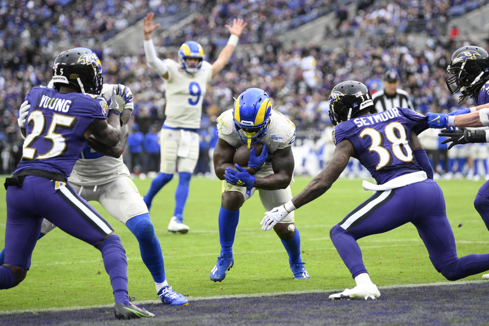 Los Angeles Rams quarterback Matthew Stafford (9) reacts as running back Sony Michel, center, runs for a touchdown during the second half of an NFL football game against the Baltimore Ravens, Sunday, Jan. 2, 2022, in Baltimore. (AP Photo/Nick Wass)