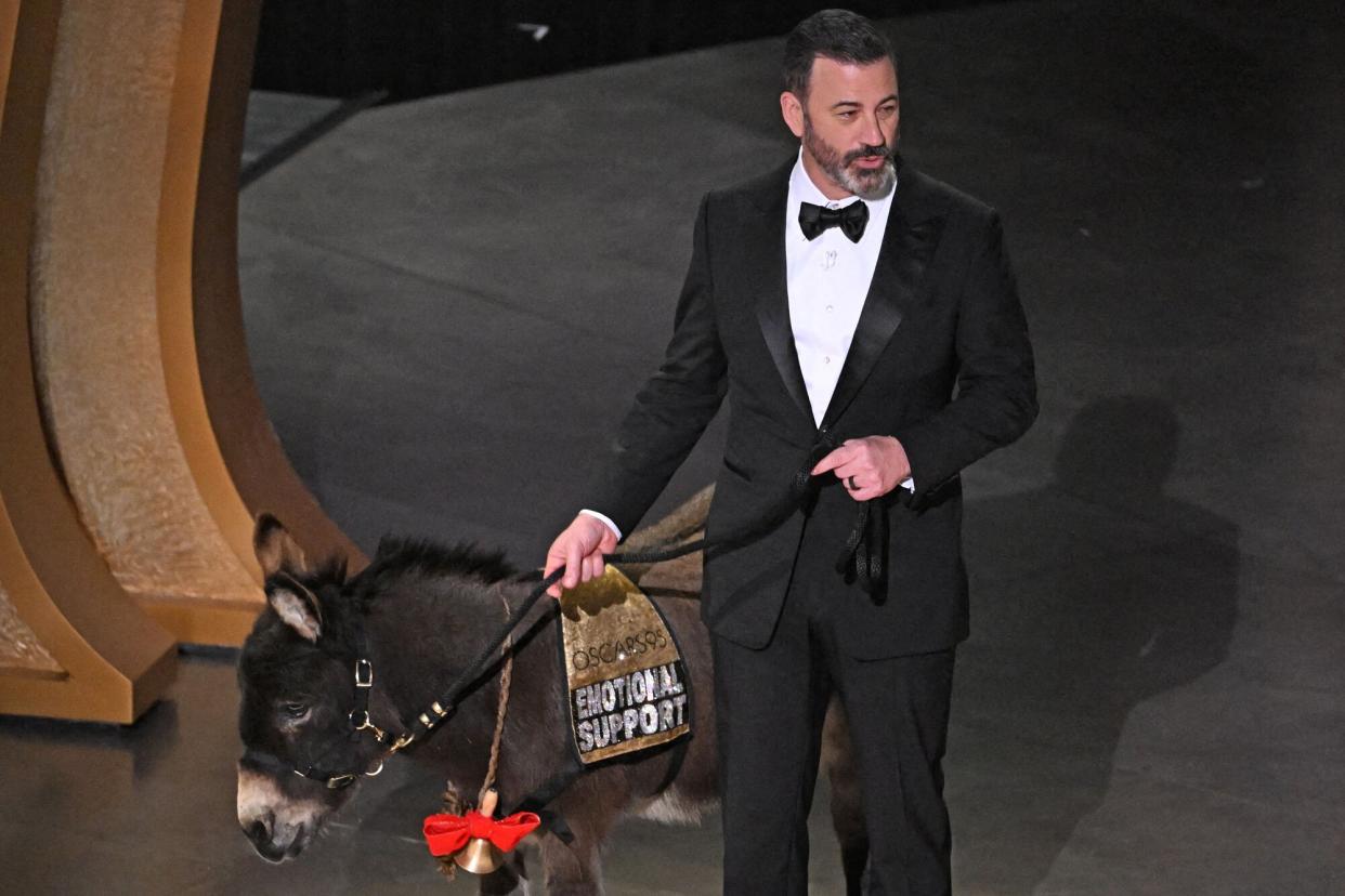 TV host Jimmy Kimmel walks onstage with a donkey during the 95th Annual Academy Awards at the Dolby Theatre in Hollywood, California on March 12, 2023.