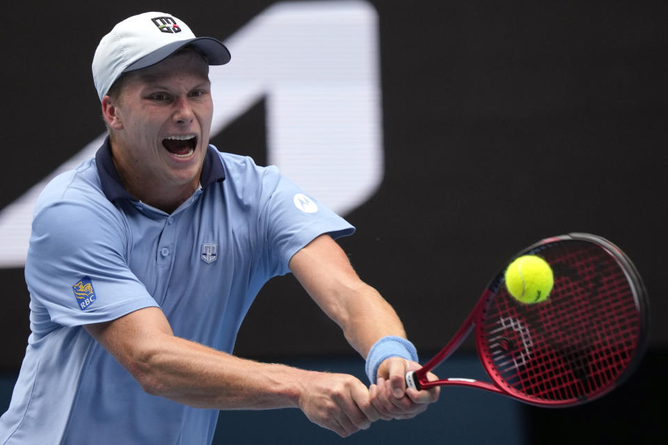 Jenson Brooksby of the U.S. plays a backhand return to Casper Ruud of Norway during their second round match at the Australian Open tennis championship in Melbourne, Australia, Thursday, Jan. 19, 2023. (AP Photo/Dita Alangkara)