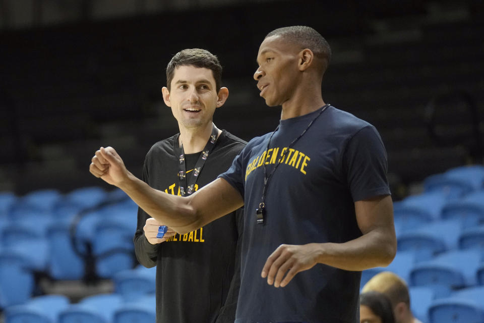 Santa Cruz Warriors coach Nicholas Kerr, left, talks with assistant coach Noel Hightower during the team's basketball practice in Santa Cruz, Calif., Friday, Jan. 12, 2024. Each day, Kerr strives to find a balance between fun and fire while leading Golden State's developmental G League team minus all the big stars - like Stephen Curry - his famous father, Steve Kerr, gets to work with every day. (AP Photo/Jeff Chiu)