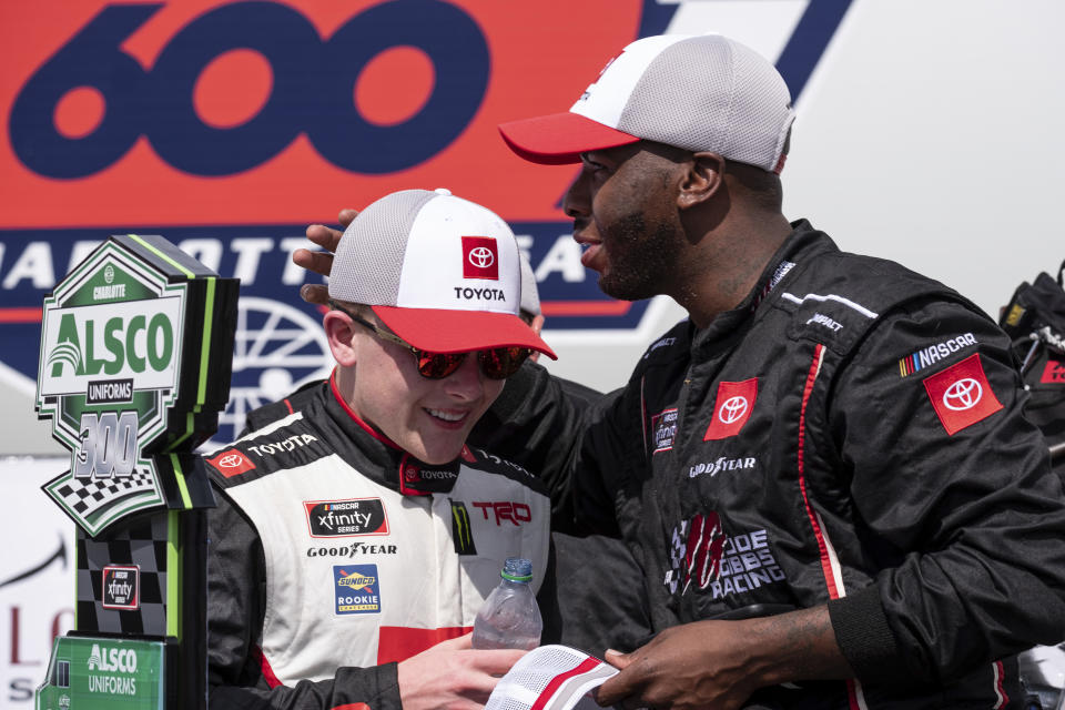 Ty Gibbs, left, celebrates with a crew member after winning the Alsco Uniforms 300 NASCAR Xfinity Series auto race at Charlotte Motor Speedway on Saturday, May 29, 2021 in Charlotte, NC. (AP Photo/Ben Gray)