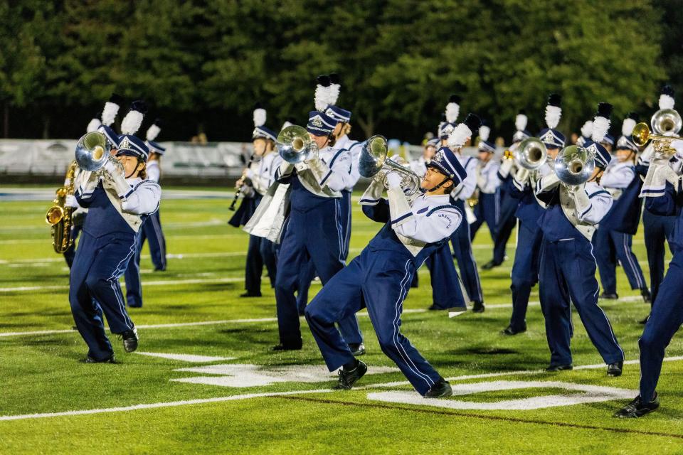 The Granville Marching Blue Aces perform at home during the game against Heath.