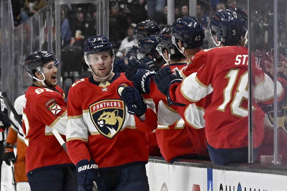 Florida Panthers defenseman Brandon Montour, left, celebrates with center Carter Verhaeghe (23) and teammates after Montour scores against the Anaheim Ducks during the first period of an NHL hockey game in Anaheim, Calif., Sunday, Nov. 6, 2022. (AP Photo/Alex Gallardo)