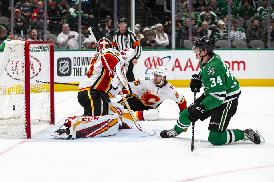 Dallas Stars right wing Denis Gurianov (34) watches as his shot goes into the goal past Calgary Flames goaltender David Rittich (33) during the first period of an NHL hockey game against the Calgary Flames, Sunday, Dec. 22, 2019, in Dallas. (AP Photo/Sam Hodde)