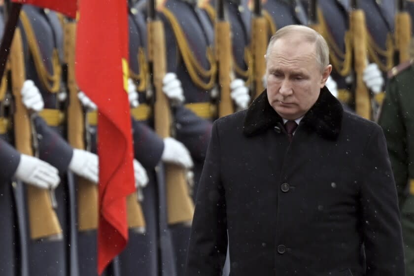 Russian President Vladimir Putin attends a wreath-laying ceremony at the Tomb of the Unknown Soldier, near the Kremlin Wall during the national celebrations of the 'Defender of the Fatherland Day' in Moscow, Russia, Wednesday, Feb. 23, 2022. The Defenders of the Fatherland Day, celebrated in Russia on Feb. 23, honors the nation's military and is a nationwide holiday. (Alexei Nikolsky, Kremlin Pool Photo via AP)