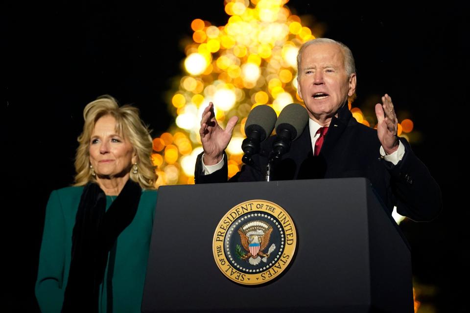 President Joe Biden speaks as first lady Jill Biden listens during the ceremony to light the National Christmas Tree on the Ellipse of the White House, Nov. 30, 2022.