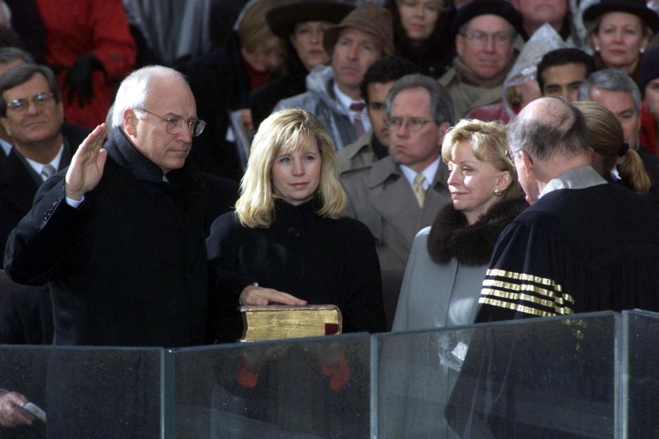 U.S. Vice President-elect Dick Cheney (L) is sworn into office by U.S. Supreme Court Justice Willaim Rehnquist (R) as his daughter Elizabeth (2nd R) holds the Bible, wife Lynne (3rd R) and daughter Mary (hidden) watch on Jan. 20, 2001 on the South Front of the U.S. Capitol. Bush was sworn in as the 43rd President of the United States. (TIMOTHY A. CLARY/AFP/Getty Images)