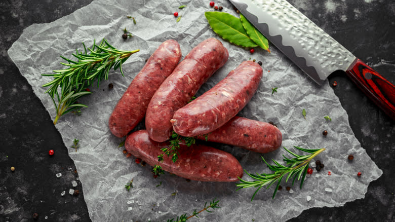Raw sausages flecked with fat