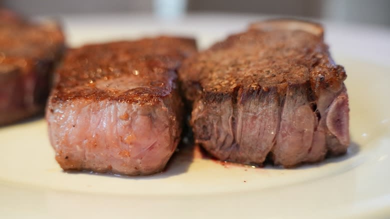 Thick steaks on plate