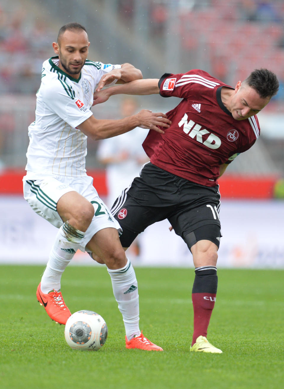 Nuremberg's Josip Drmic, right, and Leverkusen's Oemer Toprak vie for the ball during the German Bundesliga soccer match between 1. FC Nuremberg and Bayer 04 Leverkusen at Grundig-Stadion in Nuremberg, Germany, April 20,2014. AP Photo/dpa/Timm Schamberger)