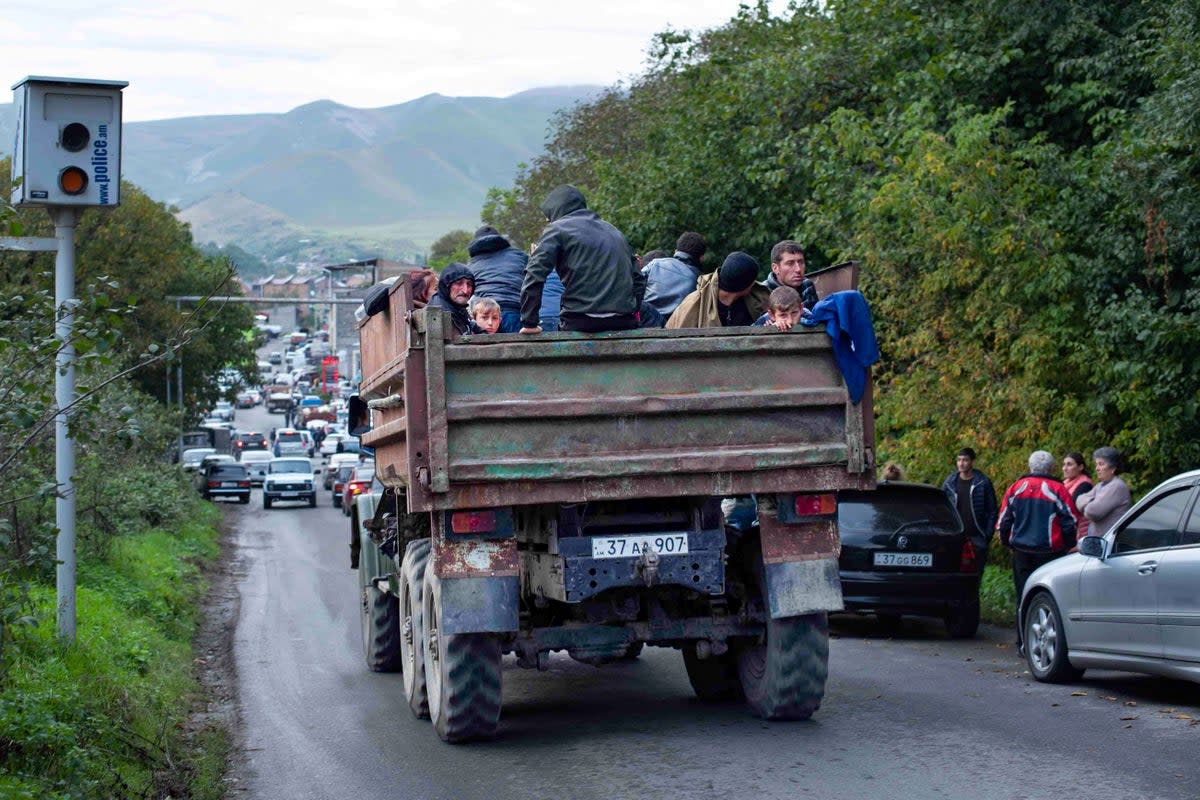 Ethnic Armenians fleeing Nagorno-Karabakh travel in the bed of a dump truck to Goris (Gayane Yenokyan)