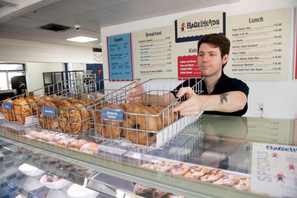 Gabe Kelly prepares the Bagelheads dining room for employee training on Tuesday, Oct. 17, 2023. Bagelheads closed for renovations five months ago and will begin serving bagels and coffee within the next few days.