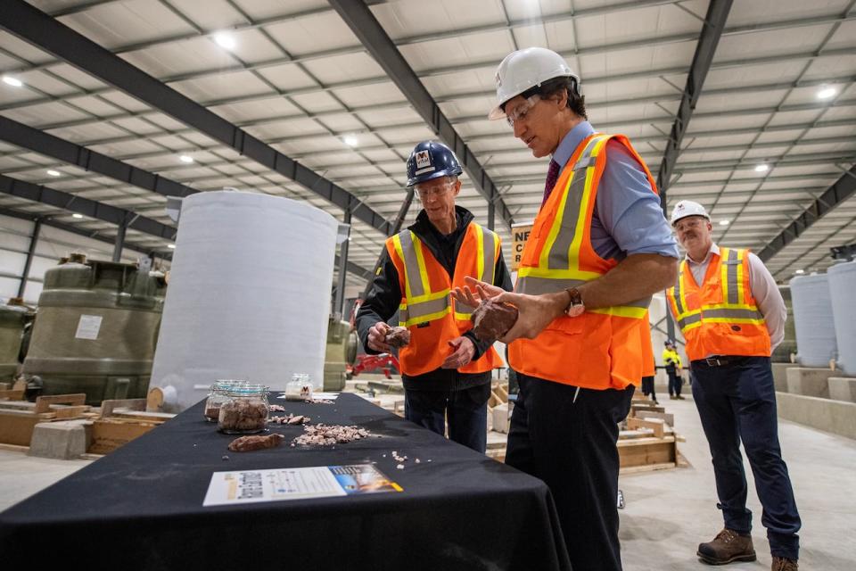 Prime Minister Justin Trudeau, right, speaks with Vincent Laniece, with Vital Metals during a  tour of the Vital Metals rare earths element processing plant in Saskatoon, on Monday, January 16, 2023. THE CANADIAN PRESS/Liam Richards