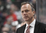 FILE - Tampa Bay Lightning head coach Jon Cooper watches from the bench as his team plays against the Minnesota Wild during the second period of an NHL hockey game in St. Paul, Minn., in this Thursday, Jan. 16, 2020, file photo. The four coaches left in the NHL playoffs have connections to each other, but they all took different paths to get to this point. (AP Photo/Hannah Foslien, File)