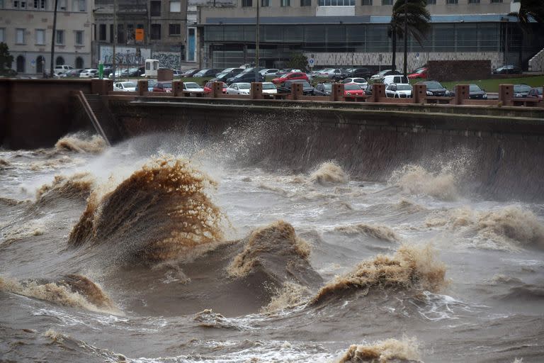 Waves crash against Montevideo's Rambla during the passage of a subtropical cyclone on May 17, 2022. (Photo by Pablo PORCIUNCULA / AFP)