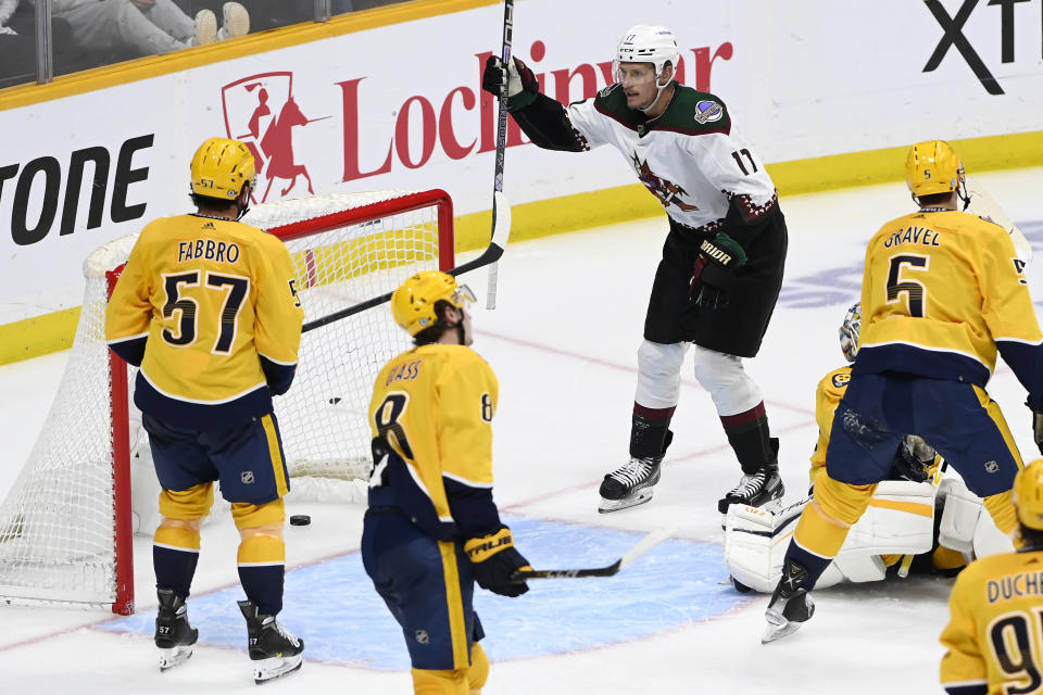 Arizona Coyotes center Nick Bjugstad (17) celebrates after a goal by teammate Lawson Crouse (not shown) during the third period of an NHL hockey game against the Nashville Predators, Monday, Feb. 13, 2023, in Nashville, Tenn. (AP Photo/Mark Zaleski)