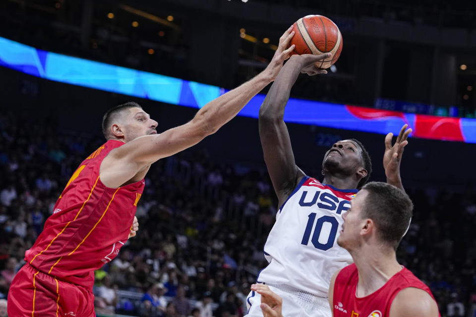 Montenegro center Nikola Vucevic (4) blocks the shot of U.S. guard Anthony Edwards (10) during the second half of a Basketball World Cup second round match in Manila, Philippines Friday, Sept. 1, 2023. (AP Photo/Michael Conroy)