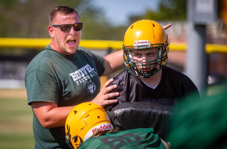 Coach Theo Evans leads a Des Moines Hoover football practice this month.