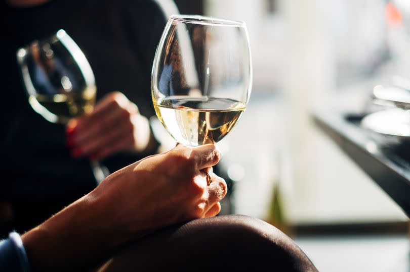 Two women sitting at a table enjoying a glass of wine