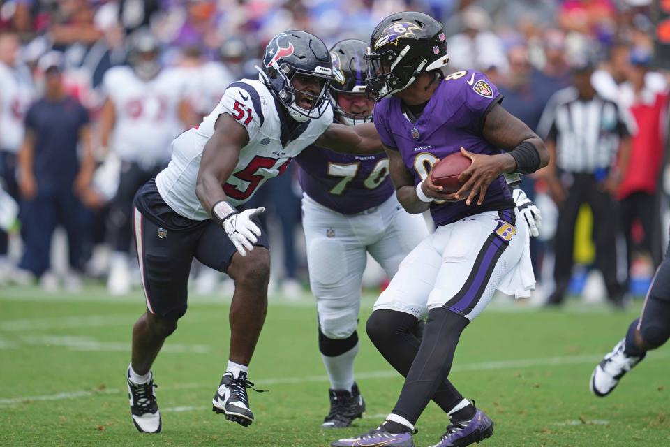 Baltimore Ravens quarterback Lamar Jackson (8) pressured by Houston Texans defensive end Will Anderson Jr. (51) in the second quarter at M&T Bank Stadium.