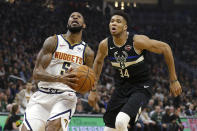 Denver Nuggets' Will Barton drives to the basket against Milwaukee Bucks' Giannis Antetokounmpo (34) during the first half of an NBA basketball game Friday, Jan. 31, 2020, in Milwaukee. (AP Photo/Aaron Gash)