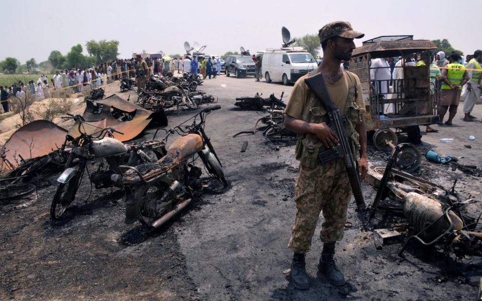 A soldier at the scene of an oil tanker explosion - Credit: REUTERS