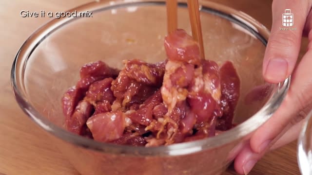 Mixing pork with marinade sauce