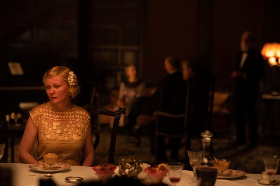 Kirsten Dunst sitting at a table