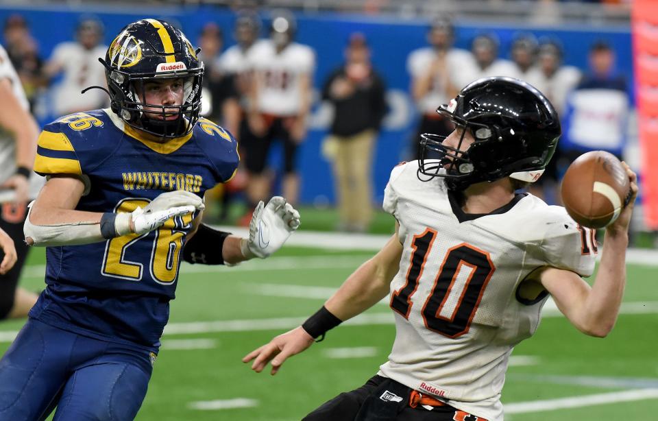 Jake Iott of Whiteford pressures Ubly quarterback Evan Peruski at the end of the first half causing an interception. Whiteford beat Ubly 26-20 in the Division 8 State Championships at Ford Field Friday.