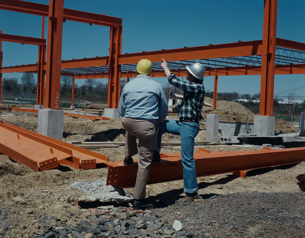 Construction workers looking at construction site