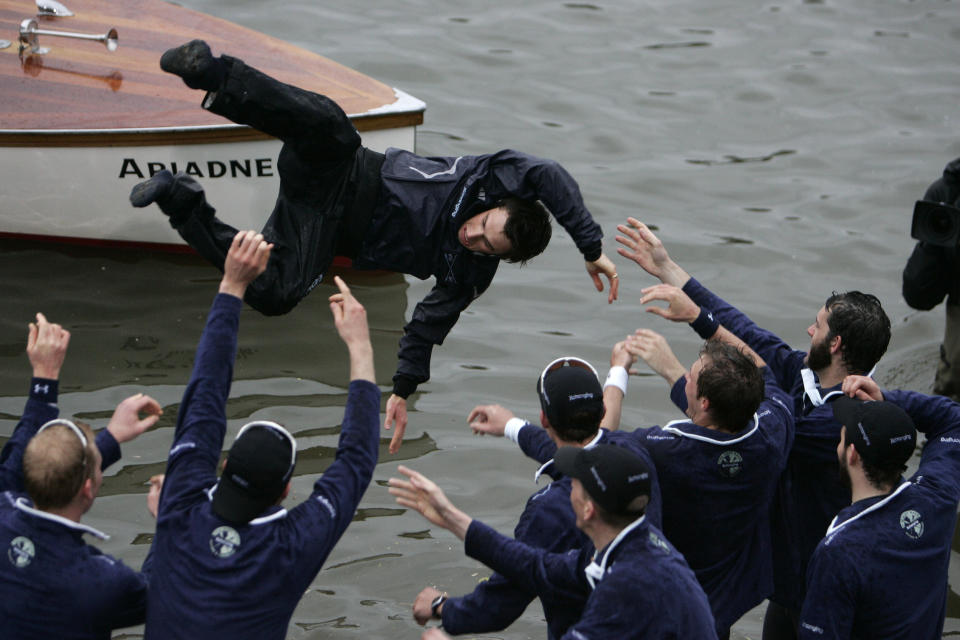 FILE - Members of the Oxford University rowing team throw their cox Nicholas Brodie, centre, into the river after beating Cambridge University, at the 154th annual Boat Race on the River Thames, London, Saturday, March 29, 2008. Jumping into London’s River Thames has been the customary celebration for members of the winning crew in the annual Boat Race between storied English universities Oxford and Cambridge. Now researchers say it comes with a health warning. (AP Photo/Lefteris Pitarakis, File)