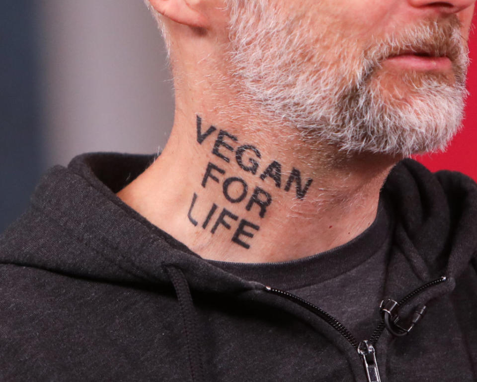 "Vegan for life" in all caps on the side of his neck
