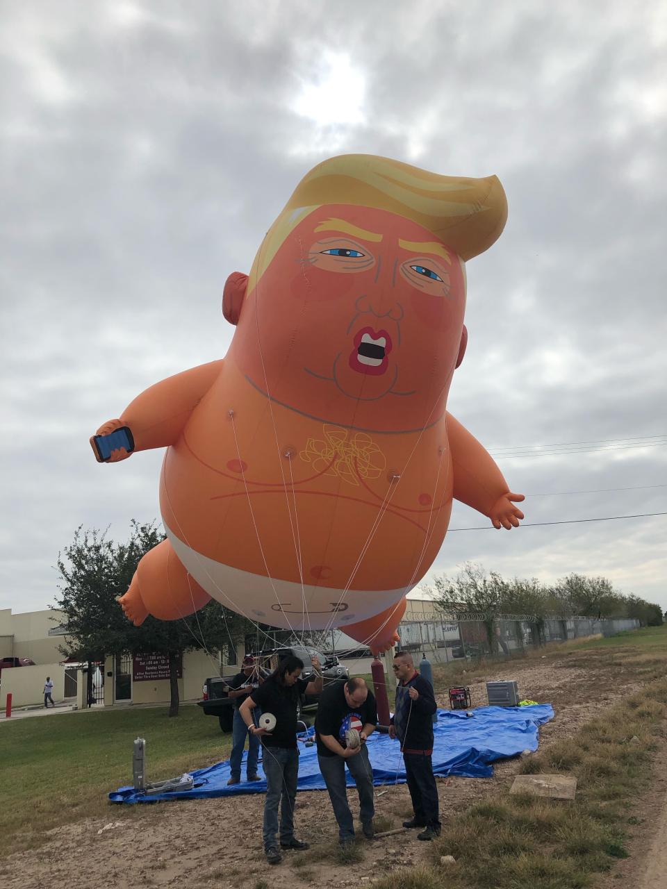 McAllen, TX  Jan. 10, 2019. 
Protestors inflate and float a giant Trump Baby blimp across the street from the Border Patrol station in McAllen, TX where President Trump was scheduled to visit. 
 (Via OlyDrop)