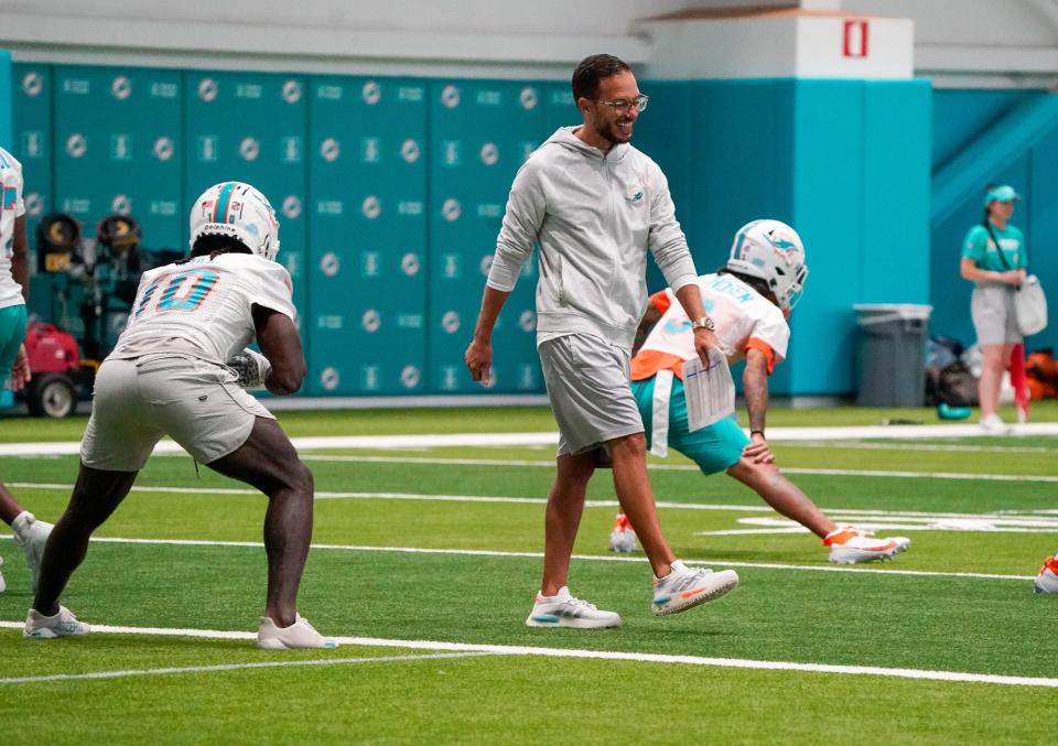 Miami Dolphins wide receiver Tyreek Hill (10) and head coach Mike McDaniel participate in training camp Wednesday at Baptist Health Training Complex in Miami Gardens.