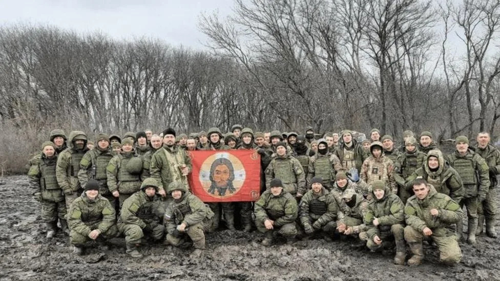 Group of soldiers holding flag