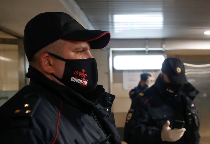 Police officers check pedestrians' documents in Moscow