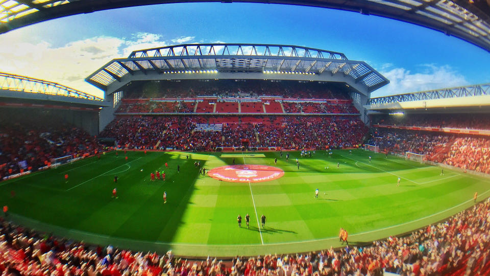 Panorama of Anfield stadium, taken from the Centenary Stand, showing from left to right: The Kop, the new Main Stand and the Anfield Road Stand