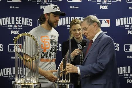 Oct 29, 2014; Kansas City, MO, USA; MLB commissioner Bud Selig presents San Francisco Giants pitcher Madison Bumgarner with the MVP trophy next to the Commissioners Trophy after game seven of the 2014 World Series against the Kansas City Royals at Kauffman Stadium. Mandatory Credit: Charlie Neibergall/Pool Photo via USA TODAY Sports