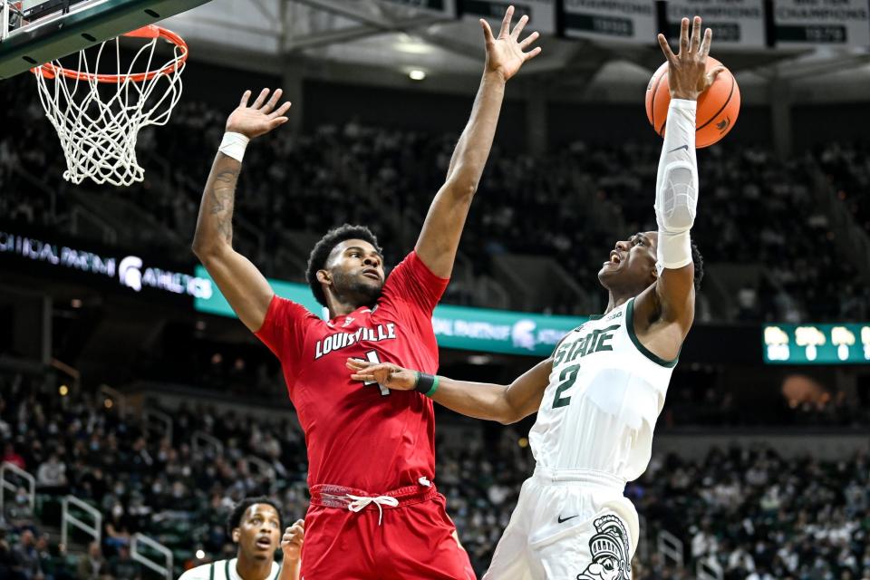 Michigan State's Tyson Walker, right, loses the ball as Louisville's Roosevelt Wheeler defends during the first half on Wednesday, Dec. 1, 2021, at the Breslin Center in East Lansing.

211201 Msu Lville 038a