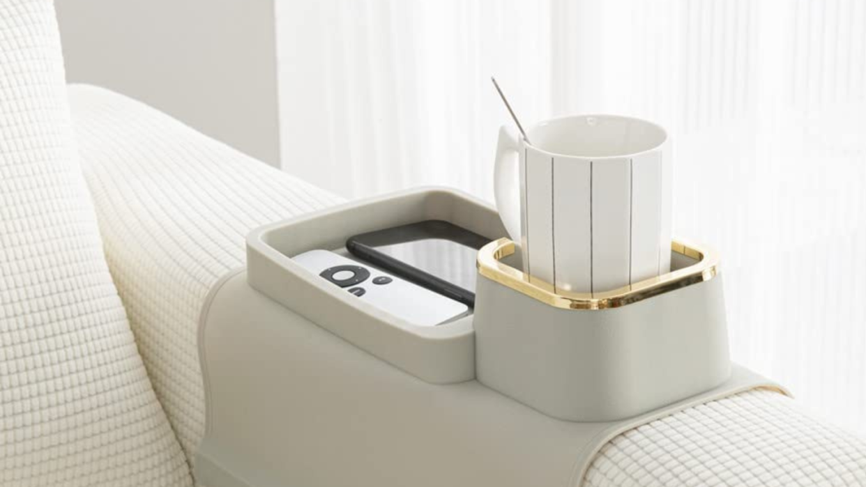 silicon gray tray that folds over a couch with a cup holder and tray for phone remote etc