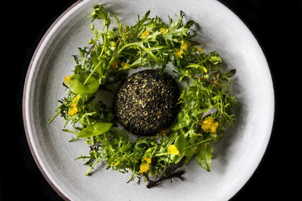 A dome of ricotta and puffed amaranth is surrounded by a wreath of salad greens, including miner’s lettuce, which grows wild in the area as a weed.