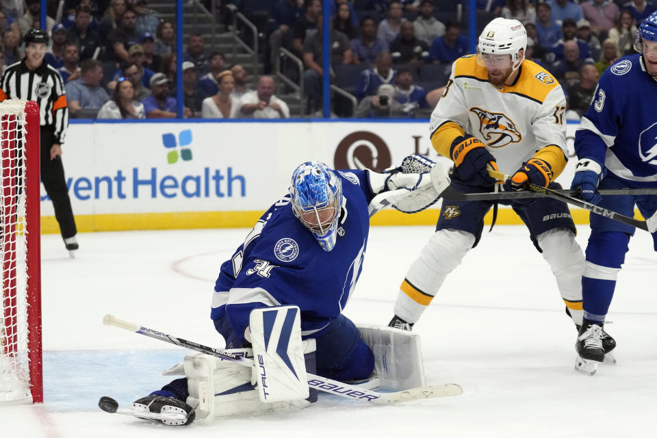 Tampa Bay Lightning goaltender Jonas Johansson (31) makes a skate save on a shot by Nashville Predators center Yakov Trenin (13) during the third period of an NHL hockey game Tuesday, Oct. 10, 2023, in Tampa, Fla. (AP Photo/Chris O'Meara)