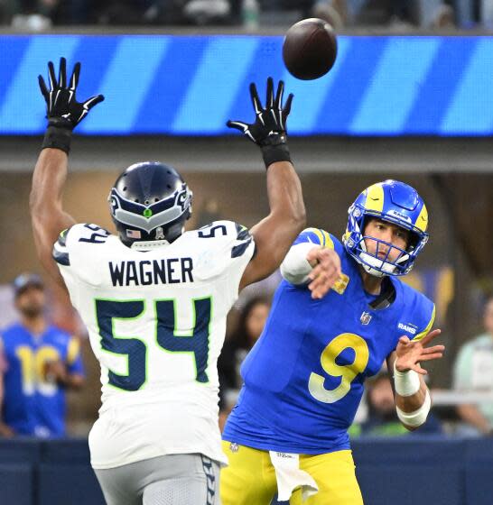 Rams quarterback Matthew Stafford throws a pass past Seahawks linebacker Bobby Wagner.