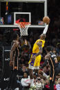 Los Angeles Lakers forward LeBron James, center, dunks during the second half of an NBA basketball game against the Atlanta Hawks, Friday, Dec. 30, 2022, in Atlanta. (AP Photo/Hakim Wright Sr.)