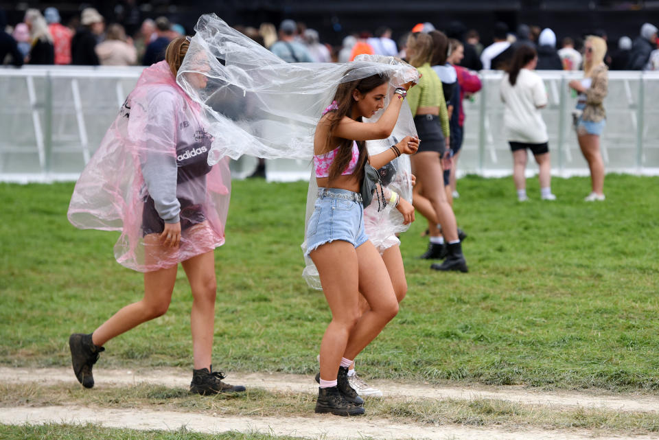 <p>Festival goers put on ponchos as the rain falls on Day 1 of Leeds Festival 2021 at Bramham Park on August 27, 2021 in Leeds, England. (Photo by Matthew Baker/Getty Images)</p>
