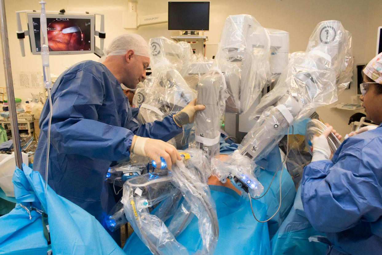 Pioneering: consultant Greg Shaw operates on patient David Ferris using the robot: Jeremy Selwyn